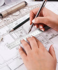 Person using a ruler and pen on architectural plans, focused on measurements for the Pro Grade Cabinet Hardware Jig Kit.