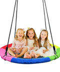 Three children sitting on a colorful 40 Inch Saucer Tree Swing For Kids With 900D Oxford Waterproof Fabric And 900 Lb Weight Capacity