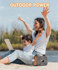 Mother and child on beach with laptop using Power Station 300W Solar Generator 280Wh Portable Outdoor Power Bank with 110V AC Outlets.