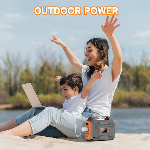Mother and child on beach with laptop using Power Station 300W Solar Generator 280Wh Portable Outdoor Power Bank with 110V AC Outlets.