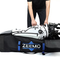 Person placing golf clubs into full open golf club travel case with wheels airline approved protective cover for cart bags.