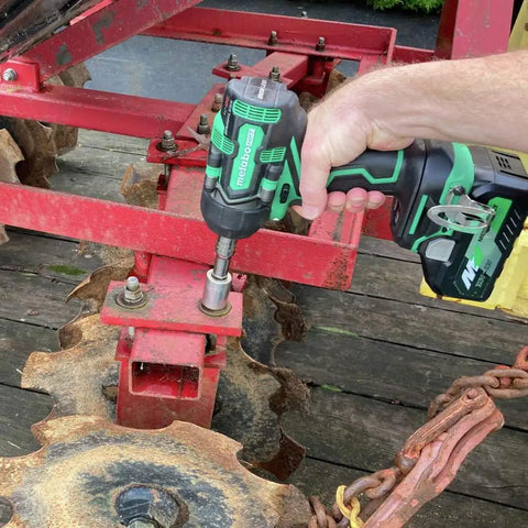 Using 36V MultiVolt Half Inch Mid Torque Cordless Impact Wrench on red metal equipment
