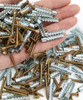 10 Pieces Carbon Steel Drive Anchors With Screws Tree Shaped Hollow Wall Anchors For Drywall And Furniture Repair Durable Metal Expansion Screws 3.5 Cm Length For Stronghold And Long Lasting Installations scattered on a hand and table.