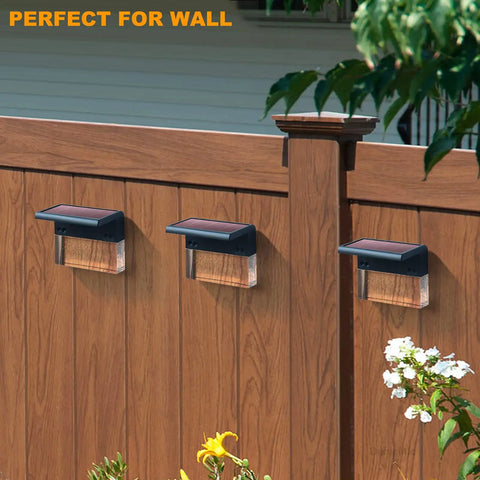 6 Pack Solar Deck Lights LED 10 Lumen Outdoor Lighting for Fence Patio Garden Yard Backyard Waterproof With 2 Lighting Modes Warm White Color Changing Acrylic Bubbles mounted on a wooden fence.