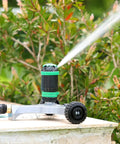 Gear Drive Sprinkler With Wheeled Base 5 Pattern Adjustable Lawn Sprinkler for yard garden use on a stone surface