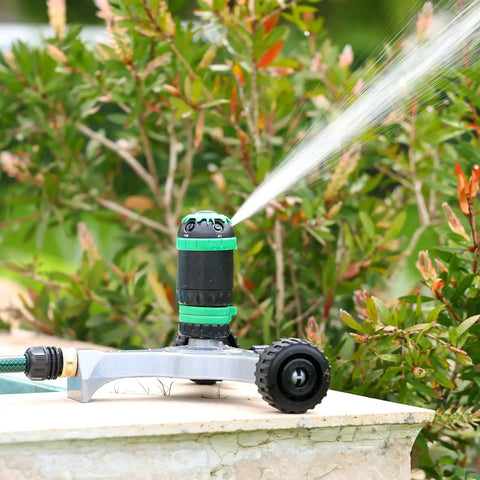 Gear Drive Sprinkler With Wheeled Base 5 Pattern Adjustable Lawn Sprinkler for yard garden use on a stone surface