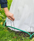 100 Pack Landscape Staples 6 Inch 11 Gauge Beefy Heavy Duty Hot Dip Galvanized Steel Garden Stakes securing a tarp on grass