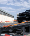 ProSeries Beefy Axle Strap Tie Down Kit With Wire Hook Ratchet Straps securing black SUV on flatbed.