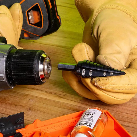 Step Drill Bit 14 Double Fluted 3/16 to 7/8 Inch with Easy Read Step Markings being held next to a drill, showcasing hex shank