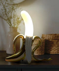 Banana Shaped Table Lamp With LED Night Light Modern Resin Banana Lighting Fixture for living room on a dark surface