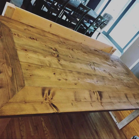 Premium Oil Based Penetrating Interior Wood Stain With Low Voc Levels For A Dang Good Natural Wood Look That Glides On Easy And Enhances Real Grain Texture In A Handy Half Pint Can applied on a rustic wooden table surface.