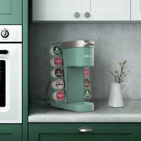 Keurig K Mini Cup Organizer Holder Holds 10 Pods Space Saving Acrylic Rack next to Keurig machine on countertop