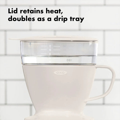 Single Serve Pour Over Coffee Maker With Auto Drip Tank For A Balanced Brew and heat retaining lid on tile background