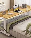Straight Up Durable Height Adjustable Overbed Table With Easy Glide Locking Casters Mobile Laptop Desk For Bedroom Or Sofa on a bed with laptop and books.
