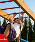 Child playing on backyard playground swing set with monkey bar and belt swings for kids, outdoor playset with trapeze bar and climbing frame.