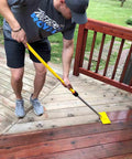 Man using Pro Extension Pole 3 To 6 Ft With Twist-Lok Locking, External Chuck And Collet on wooden deck cleaning task