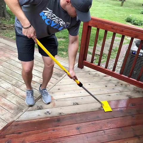 Man using Pro Extension Pole 3 To 6 Ft With Twist-Lok Locking, External Chuck And Collet on wooden deck cleaning task
