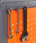 Hanging wrenches and adjustable pliers on pegboard of Badass Heavy Duty Steel Workbench And Garage Tool Organizer.