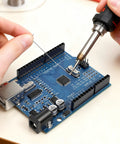 Hands soldering components on Arduino Compatible ATmega328P Microcontroller Board With USB Cable For Beginners And Pros, 7-12V Vin