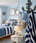 Badass Vintage Vibes 10 Inch Cast Iron Nautical Anchor Hook For Heavy Duty Wall Storage And Totally Rad Farmhouse Decor, mounted in a coastal bedroom.
