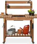 Mobile Garden Potting Bench With Sliding Tabletop Outdoor Wood Workstation with tools and plants on storage shelves, brown finish.