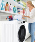 Woman folding clothes on Magnetic Laundry Guard 24 Inch Countertop Shield For Washer And Dryer Metal Laundry Topper Washing Machine And Dryer Countertop Guard Heavy Duty Powder Coat Steel White Fits Most Front Load Machines Built To Last