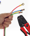 Hand holding wires with a crimping tool and 300 Piece Insulated Wire Terminal Kit With Butt Ring Spade And Quick Disconnect Crimp Connectors.