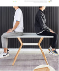 Two people sitting on a slick modern white dining table with scratch resistant top and heavy duty metal bottom shelf.