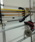 Garage Door Organizer Rack for Fishing Gear and Tools 18 Inch ABS Plastic Rod Holder on a 5-panel door.