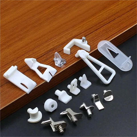 Assorted plastic and metal shelf support clips on wooden surface, part of Rose Gold Plastic Shelf Support Clips 30 Pack For Cabinets And Cupboards Partition Plate Fixing Brackets For Sturdy Organization Anti Oxidation Durable Frame Keeps Items Secure And Neat.