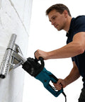 Man using a Heavy Duty 27 Inch Spray Foam Cutter Saw for open cell insulation removal on a foam wall.