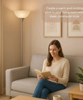 Dope Silver Torchiere Floor Lamp With White Opal Shade Modern Standing Fixture For Living Room Bedroom Or Office 72 Inch Tall E26 Base Compatible Soft Easy On The Eyes Lighting next to a woman reading on a sofa