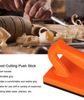 Pro Grade Direct Push Block For Table Saws, ABS Woodworking Push Stick in orange near wood shavings and tools.