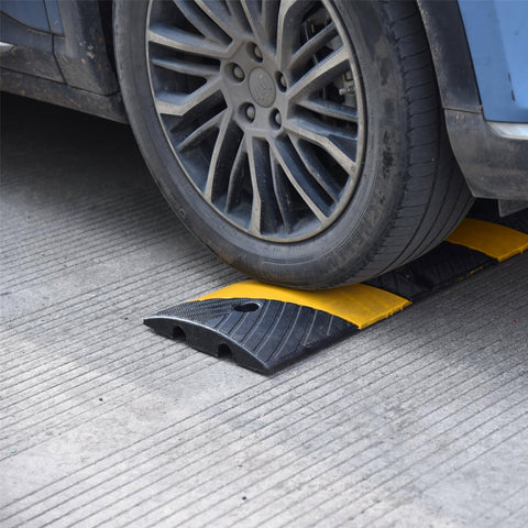 Heavy Duty Rubber Speed Bump 6 Foot Ramp With Integrated Cable Cover under car tire on concrete surface