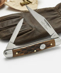 Classic Jig Bone Pen Knife With Two Stainless Steel Blades Compact 2.75 Inch Closed Pocket Knife for Men on leather glove.