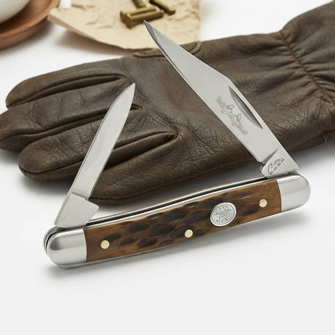Classic Jig Bone Pen Knife With Two Stainless Steel Blades Compact 2.75 Inch Closed Pocket Knife for Men on leather glove.