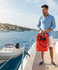 Man holding 6 Gallon Portable Marine Fuel Tank With Leak Proof Seal Level Gauge And Hose on boat deck