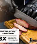 1st Choice black nitrile disposable gloves, XXL, used to carve meat on a wooden cutting board