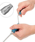 Hands using Heavy Duty 6 Ft Stainless Steel Drain Auger Snake for clogs with flexible claw grabbing debris.