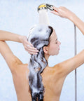 Person using Vitamin C Shower Head Filter With Hose And 3 Replacement Balms, Handheld High Pressure Filtered Shower Head in shower