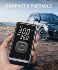 Cordless Portable Tire Inflator Mini Air Pump with Digital Pressure 150 PSI held in hand in front of car