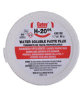 White container of water soluble paste flux, front view, labeled with safety warnings, 1.7 oz size.