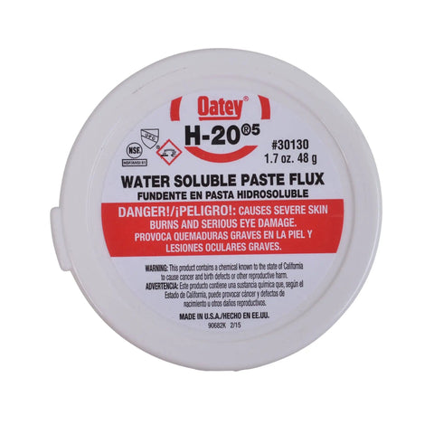 White container of water soluble paste flux, front view, labeled with safety warnings, 1.7 oz size.