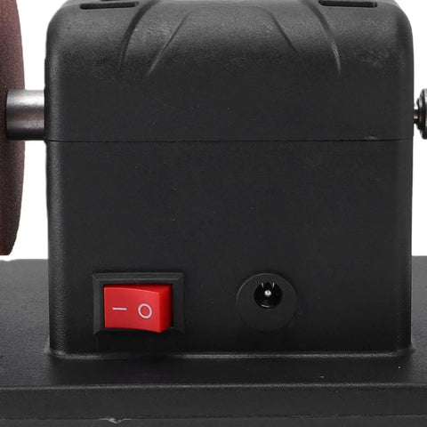 Eujgoov Cordless Mini Bench Grinder With Dual Grinding Wheels And Variable Speed Up To Six Thousand Rpm For 48 11 Battery Packs showing power switch and motor side view.