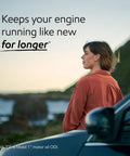 Woman standing beside a car with the ocean in the background, promoting Top Shelf Full Synthetic Motor Oil 0W20 Five Quint Container.