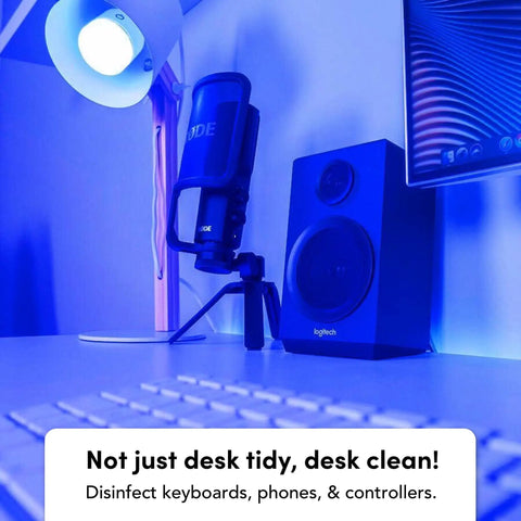 Wi-Fi Smart LED Light Bulb 1100 Lumens, Full RGBW Color illuminating a desk setup with speaker and microphone, HEV Antibacterial Mode