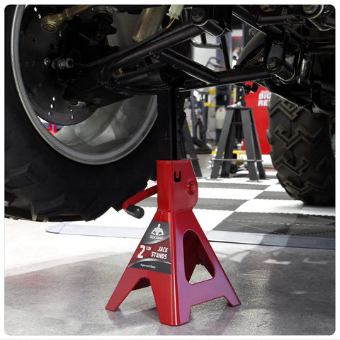 Jack Boss 2-ton jack stand under a car; red steel low-profile design.
