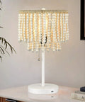 Boho Table Lamp With USB Charging Port and Birch Wood Bead Details, showcasing warm glow, white finish, on bedside table