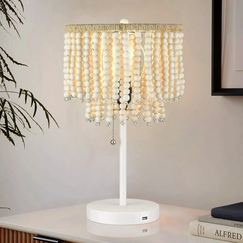Boho Table Lamp With USB Charging Port and Birch Wood Bead Details, showcasing warm glow, white finish, on bedside table