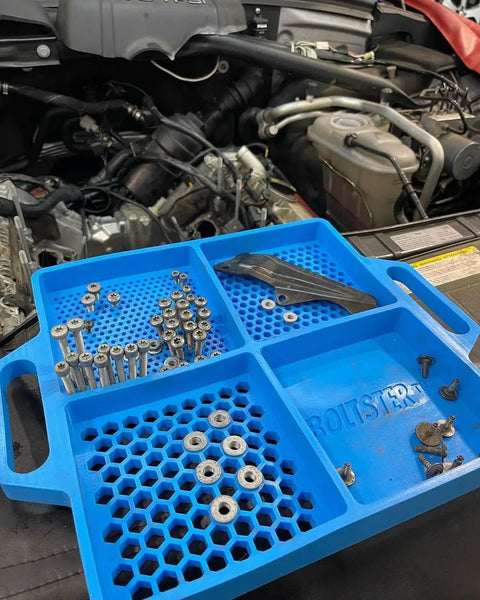 Blue Silicone Fastener Tray For Bolts, Nuts, And Bits With Handy Handle in automotive repair setting